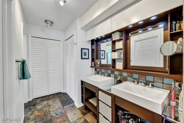 bathroom featuring vanity and decorative backsplash