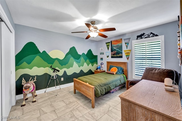 bedroom featuring ceiling fan and a closet