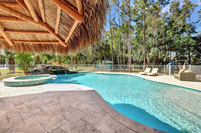 view of swimming pool with a patio and an in ground hot tub