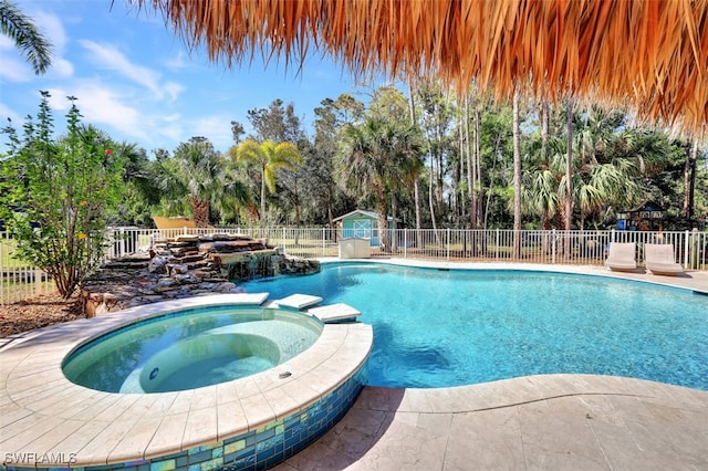 view of pool with an in ground hot tub