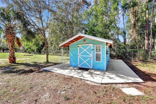 view of outbuilding featuring a yard