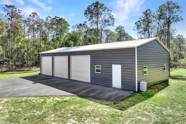 garage featuring a lawn