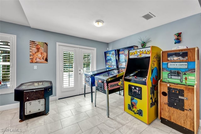 rec room featuring french doors and light tile patterned floors