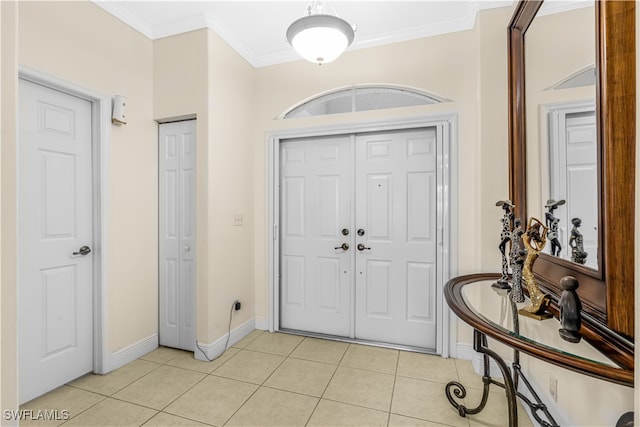 tiled entryway featuring ornamental molding