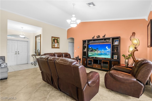 living room with ornamental molding, light tile patterned floors, and a chandelier