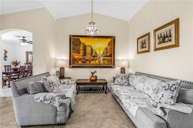 living room featuring tile patterned flooring, ceiling fan with notable chandelier, and vaulted ceiling