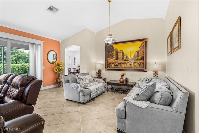 tiled living room featuring ornamental molding, vaulted ceiling, and a notable chandelier