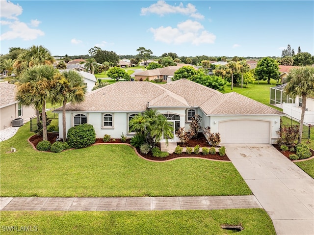 view of front of house featuring cooling unit, a front yard, and a garage