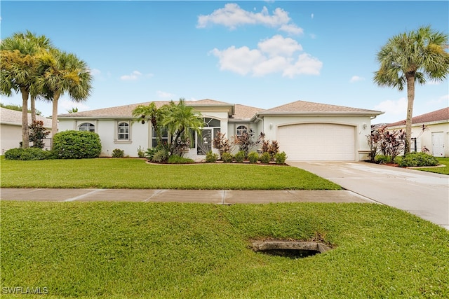 view of front of home featuring a front lawn and a garage