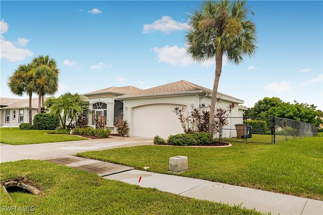 mediterranean / spanish home with a front lawn and a garage