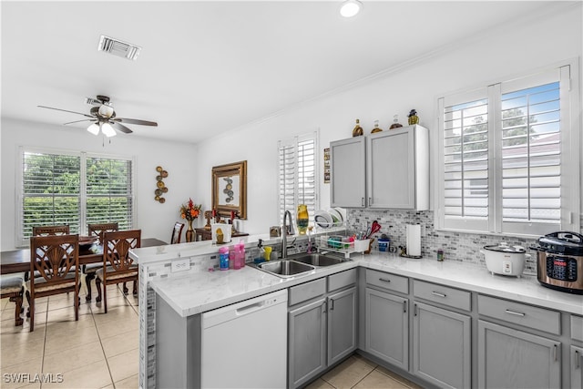 kitchen featuring dishwasher, kitchen peninsula, sink, and ceiling fan