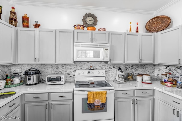 kitchen featuring ornamental molding, white appliances, light stone counters, and tasteful backsplash