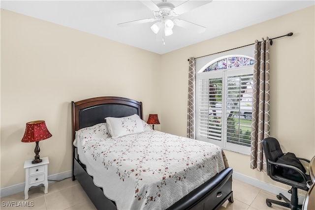 bedroom with ceiling fan and light tile patterned floors