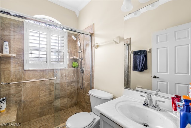 bathroom featuring crown molding, vanity, toilet, and walk in shower