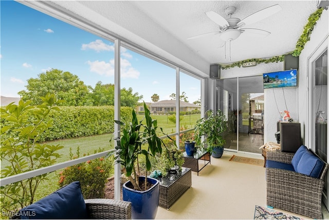 sunroom / solarium featuring ceiling fan