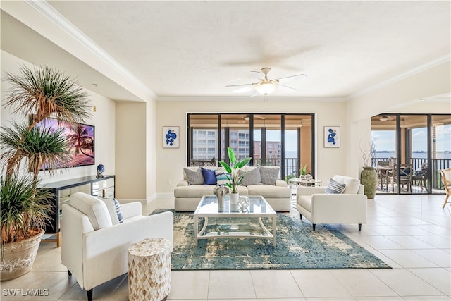 tiled living room with crown molding and ceiling fan