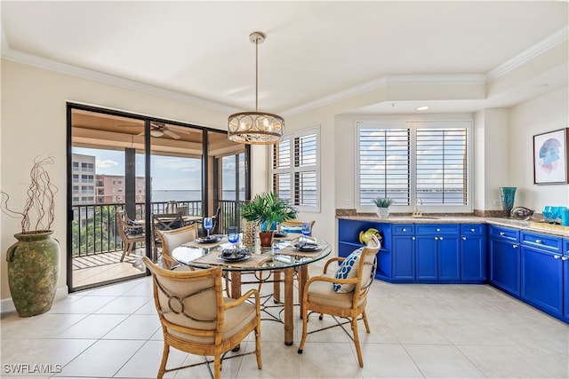 tiled dining space with crown molding, a chandelier, and sink