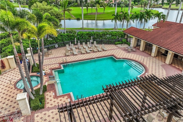 view of pool with a patio, a community hot tub, and a water view