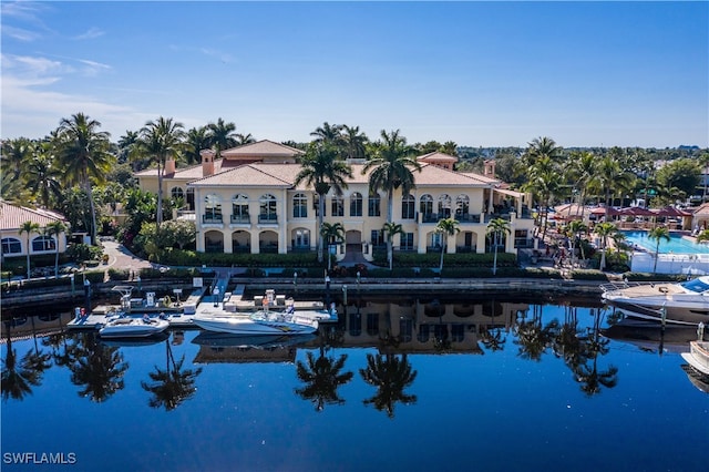 back of property featuring a water view and a balcony