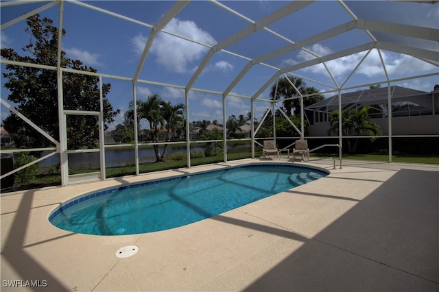 view of pool featuring glass enclosure and a patio