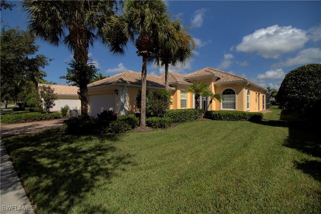 mediterranean / spanish-style house with a front lawn