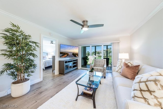 living room with ceiling fan, ornamental molding, and light hardwood / wood-style floors