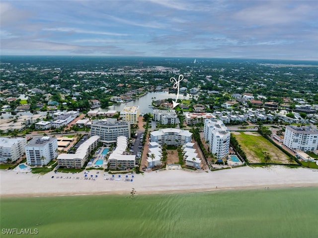 birds eye view of property featuring a view of city, a water view, and a view of the beach