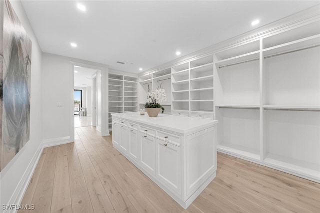 walk in closet with light wood finished floors and visible vents