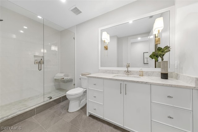 full bathroom with a stall shower, visible vents, vanity, and toilet