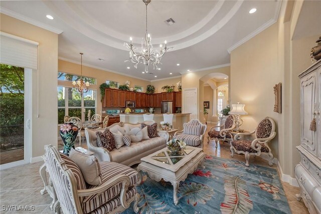 tiled living room with ornamental molding, a tray ceiling, and a notable chandelier