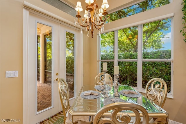 dining room featuring french doors and a notable chandelier