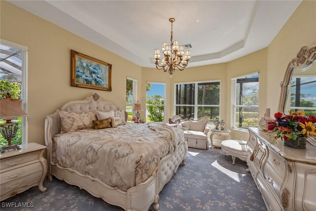 bedroom with dark carpet and a notable chandelier