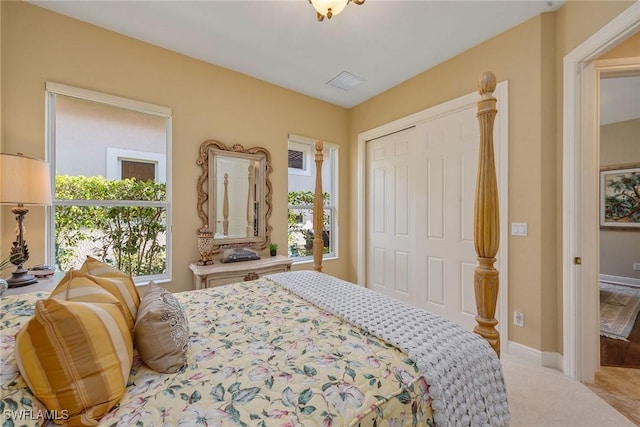 bedroom with carpet flooring, baseboards, and a closet