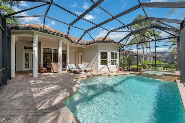 view of swimming pool featuring a lanai, an in ground hot tub, and a patio