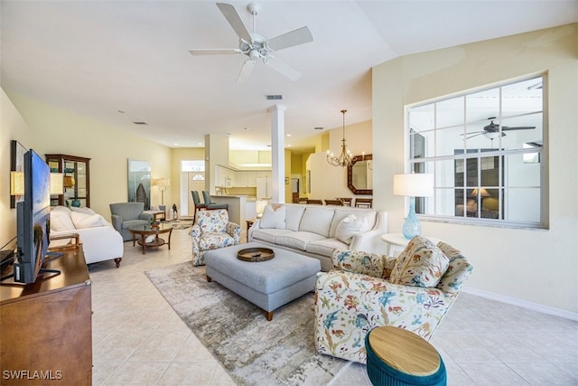 tiled living room featuring ceiling fan with notable chandelier