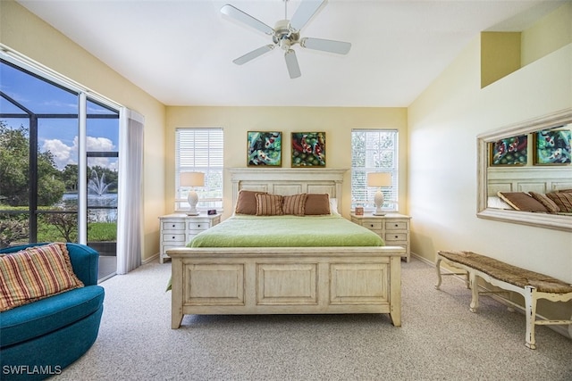 carpeted bedroom featuring ceiling fan, access to exterior, and multiple windows