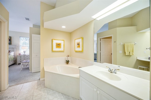 bathroom featuring vanity, a tub to relax in, and tile patterned floors