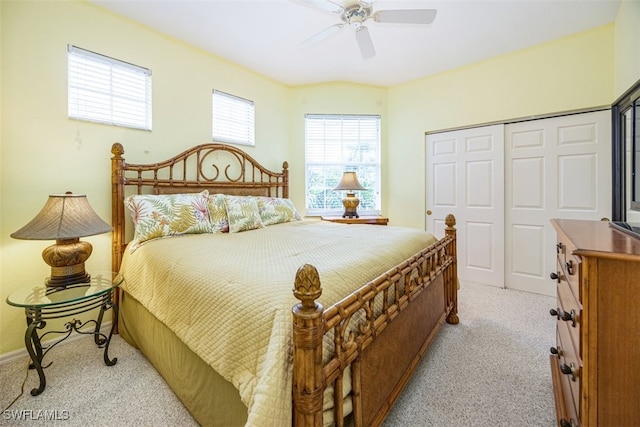 carpeted bedroom featuring ceiling fan and a closet