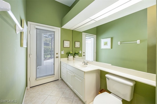 bathroom with tile patterned flooring, vanity, and toilet