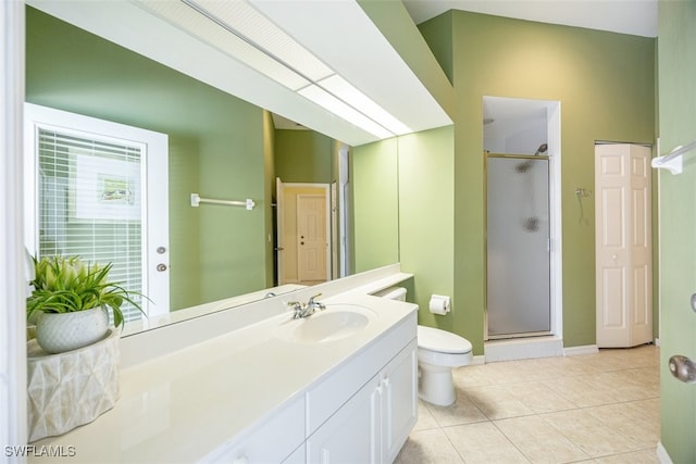 bathroom featuring tile patterned floors, vanity, toilet, and a shower with door