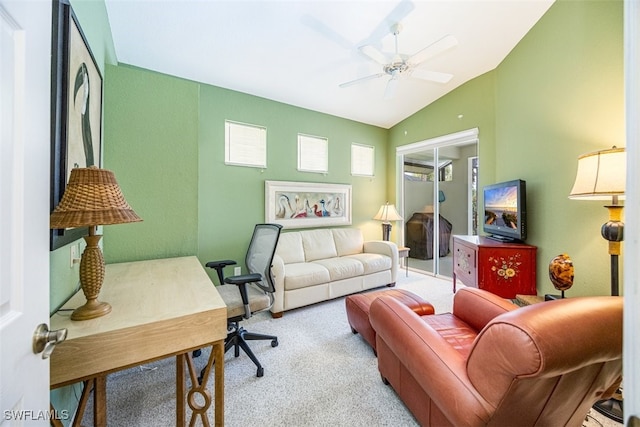 carpeted living room with ceiling fan and lofted ceiling