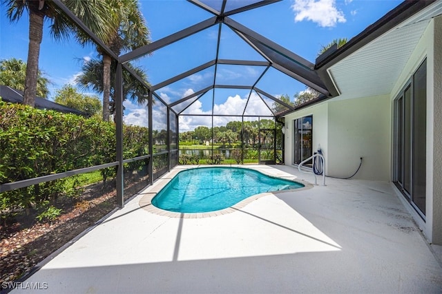 view of swimming pool featuring a patio and glass enclosure