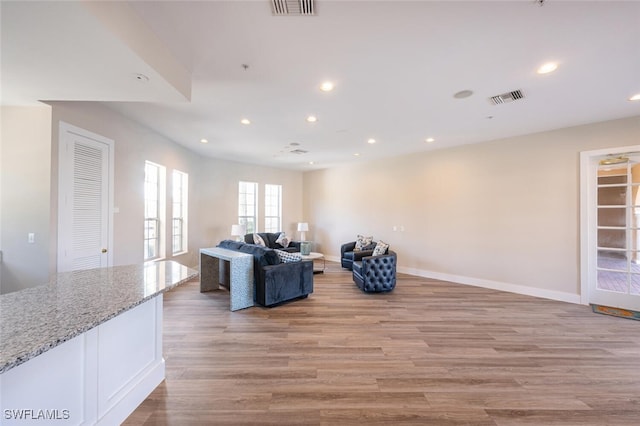 living room with french doors and light hardwood / wood-style flooring