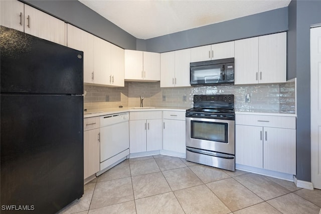 kitchen featuring black appliances, backsplash, light tile patterned floors, and white cabinets