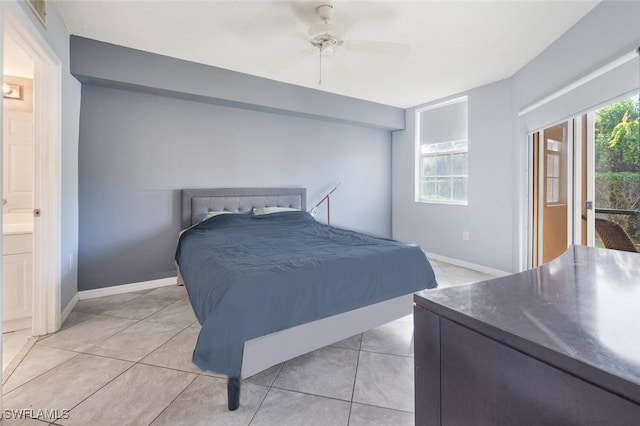 tiled bedroom featuring ceiling fan and ensuite bath