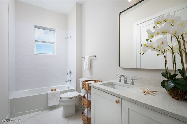 full bathroom with vanity, tiled shower / bath, and toilet