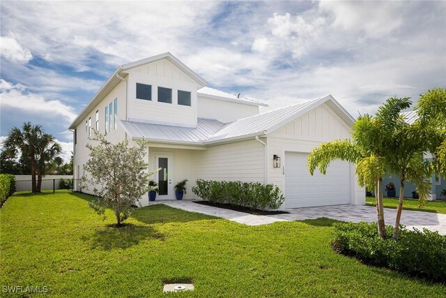 view of front of house featuring a garage and a front lawn