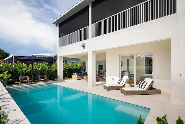 view of pool with outdoor lounge area and a patio area