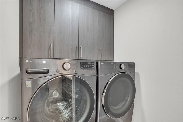 laundry area featuring cabinets and independent washer and dryer