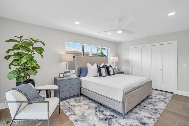 bedroom with ceiling fan, a closet, and hardwood / wood-style flooring